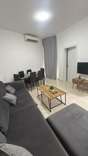 a living room with a couch and a table at Sima Suite 2 in Ashdod