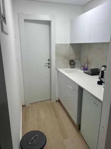 a white kitchen with a toilet in the floor at Sima Suite 2 in Ashdod