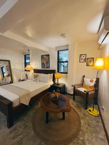 a bedroom with a bed and a table and a chair at E-Place Resort in Magallanes