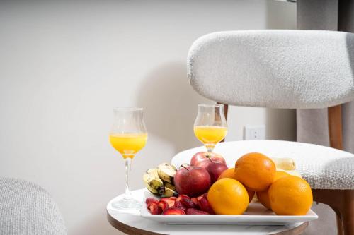 a plate of fruit and two glasses of wine at Camel Pyramids View Inn in Cairo
