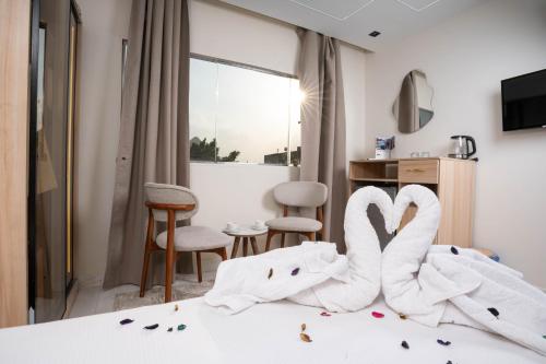 a hotel room with two swans sitting on a bed at Camel Pyramids View Inn in Cairo