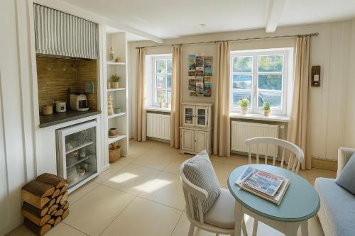 a living room with a table and a fireplace at Lodge am Meer in Glücksburg