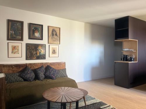 a living room with a couch and a table at Chambre avec vue in Carcassonne