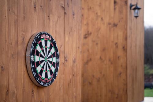 a dart board on the side of a wooden door at Kapcsolj ki Wellness Apartmanház Demjén in Demjén