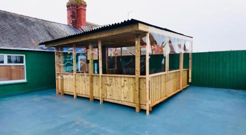 a gazebo on the back of a house at Roman apartment in Skegness