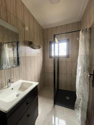 a bathroom with a sink and a shower at Résidence Belle Alliance in Yaoundé