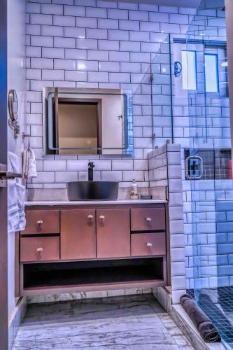 a bathroom with a sink and a mirror at Unique FAMILY CAVE Heated Pool on demand in Puerto Peñasco