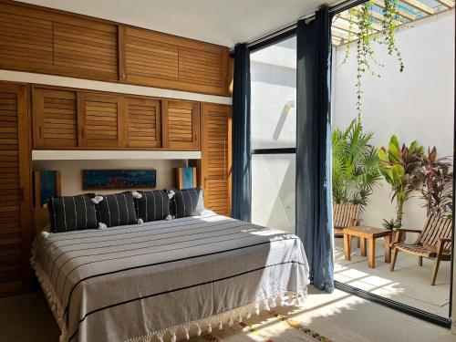 a bedroom with a large bed and a large window at Ocean View Apartment PXM in Puerto Escondido