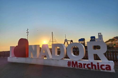 a large sign that reads madida with the sunset in the background at Nador corniche gare in Nador