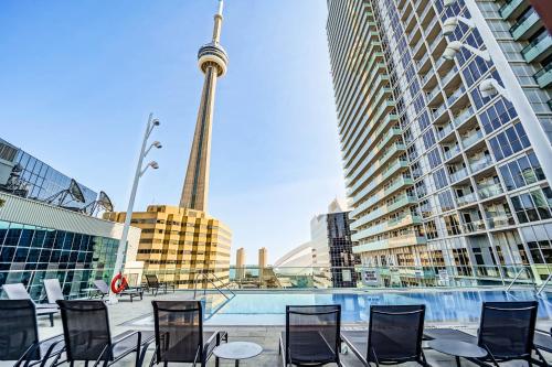 a group of chairs sitting in front of tall buildings at CHOL Furnished Suites Heart of Downtown Toronto, 2 Beds, Free Parking, CN Tower View in Toronto