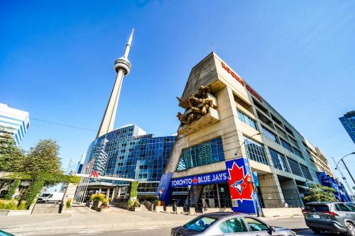 a building with a statue in front of it at CHOL Furnished Suites Heart of Downtown Toronto, 2 Beds, Free Parking, CN Tower View in Toronto