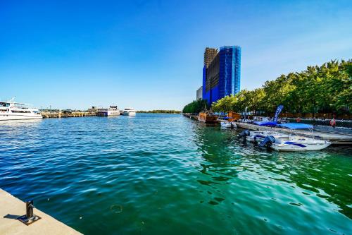 a view of a river with boats docked in a city at CHOL Furnished Suites Heart of Downtown Toronto, 2 Beds, Free Parking, CN Tower View in Toronto