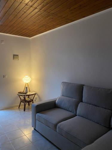 a living room with a couch and a table at Paraíso Açoreano Guest House in Achada