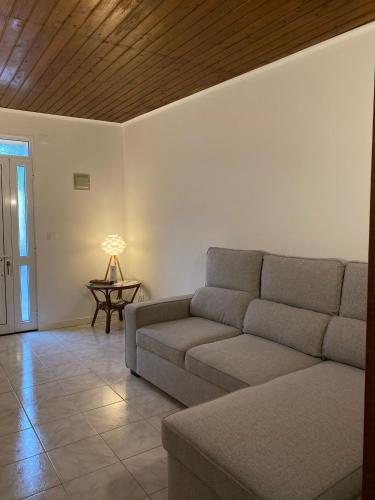 a living room with a couch and a table at Paraíso Açoreano Guest House in Achada