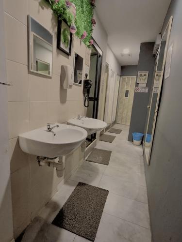 a public bathroom with two sinks and a mirror at Travelogue Guest House in Kuala Lumpur