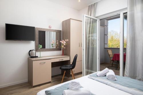 Ένα ή περισσότερα κρεβάτια σε δωμάτιο στο Apartmant & rooms Villa Rosa Medulin