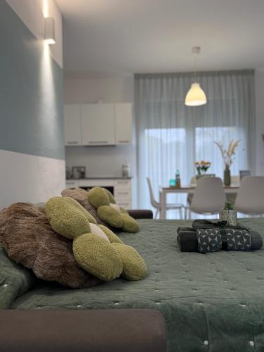 a group of stuffed animals laying on a bed at "La Terrazza di Via Roma" Delta del Po - Private Parking in Porto Viro