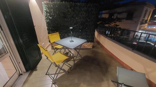 a table and chairs on the balcony of a building at La Terrazza Del Sole di Mondello in Palermo