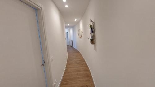 a hallway with white walls and a wooden floor at La Terrazza Del Sole di Mondello in Palermo