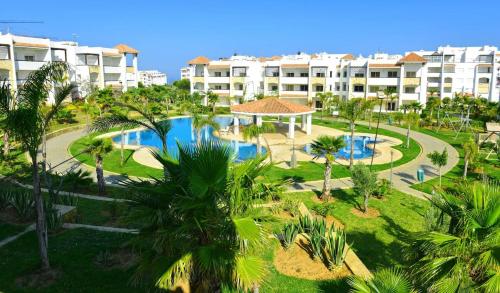an aerial view of a resort with a swimming pool at Marina Golf Appartement HS in Asilah