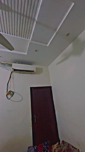 a room with a ceiling with a door and a shelf at umer farooq Hotel in Lahore