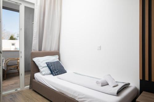 Ένα ή περισσότερα κρεβάτια σε δωμάτιο στο Apartmant & rooms Villa Rosa Medulin