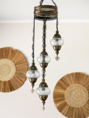 a chandelier hanging from a ceiling with two plates at Central Family Home 5 min to CBD! in Gisborne