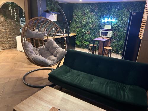 a living room with a couch and a chair at La Balinaise, a Normandy getaway in Gaillon