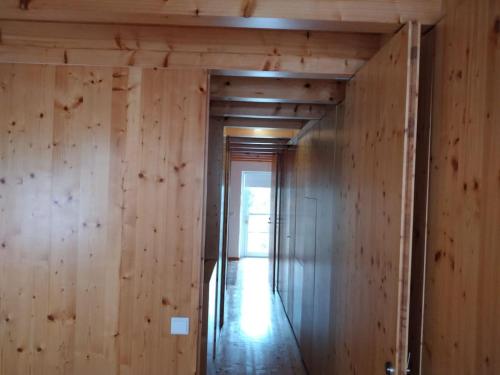 a hallway in a house with wooden walls at Casa de Condeixinha in Condeixa a Nova