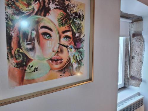 a painting of a woman on a wall at Casa de Condeixinha in Condeixa a Nova