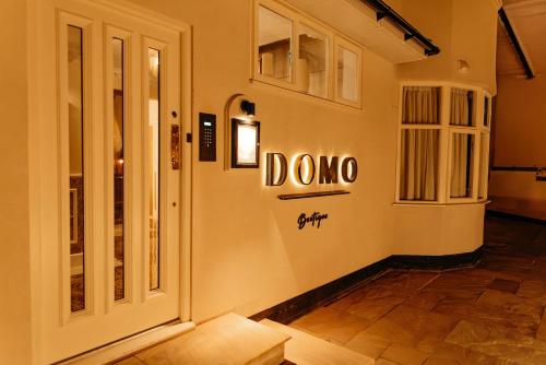 a store front with the name dmo on the wall at Domo Boutique Hotel Birmingham in Birmingham