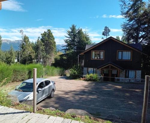 a car parked in front of a house at Apu Wasi in Villa La Angostura