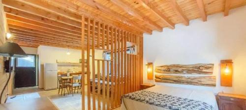 a bedroom with a bed and a dining room at Apu Wasi in Villa La Angostura