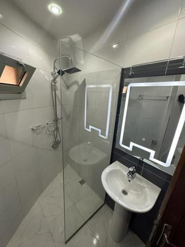 a bathroom with a sink and a glass shower at Villa Paco in Mbour