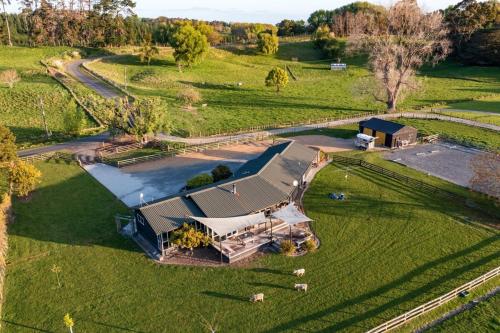 an aerial view of a large house in a field at NEW - Farm House Near Town! in Gisborne