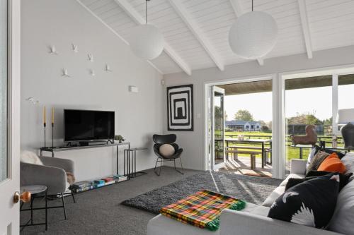 a living room with a couch and a tv at NEW - Farm House Near Town! in Gisborne
