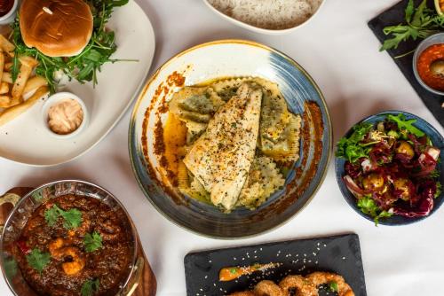 a table filled with different types of food at Domo Boutique Hotel Birmingham in Birmingham