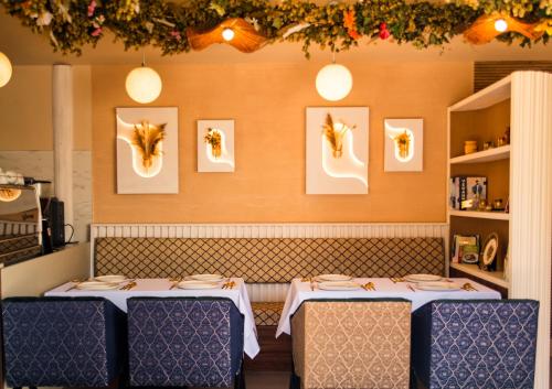 two tables in a restaurant with white tablecloths at Domo Boutique Hotel Birmingham in Birmingham