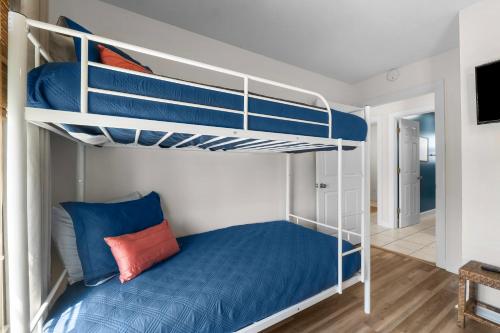 a bedroom with two bunk beds with blue sheets at Bonita Retreat in Panama City Beach
