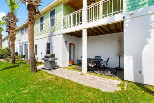 a patio with a grill next to a house at Bonita Retreat in Panama City Beach
