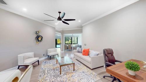 a living room with a couch and a ceiling fan at The Riverview Estates Sauna And Heated Pool in Riverview