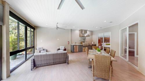 a dining room and living room with a table and chairs at The Riverview Estates Sauna And Heated Pool in Riverview