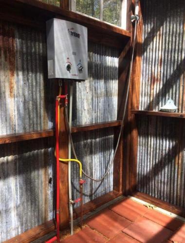 a room with a heater on a wall at Glamping at Deer Camp in Dunlap