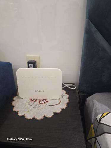 a laptop computer sitting on a table next to a bed at Vista bella luxurious apartment in Martil