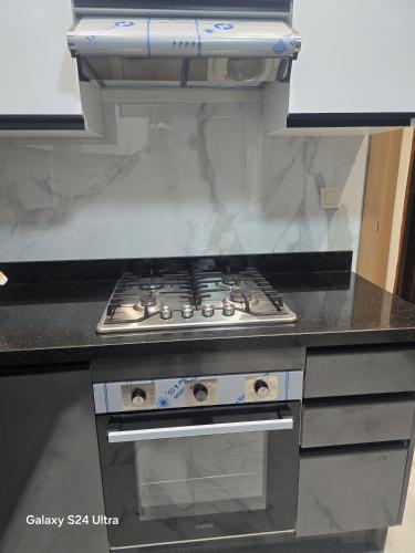 a kitchen with a stove top oven in a kitchen at Vista bella luxurious apartment in Martil