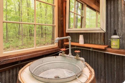 a sink in a bathroom with a window at Glamping at Deer Camp in Dunlap