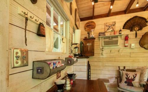 a wooden cabin with a table and a window at Glamping at Deer Camp in Dunlap