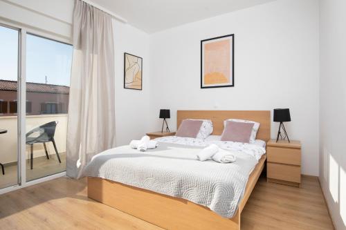 Ένα ή περισσότερα κρεβάτια σε δωμάτιο στο Apartmant & rooms Villa Rosa Medulin