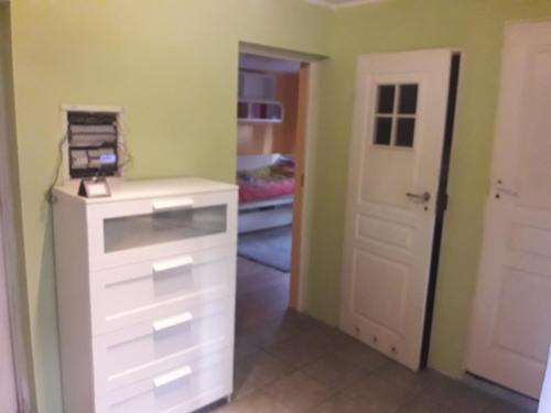 a room with a white dresser and a closet at Quiet and cozy apartment Wroclaw-Widawa in Wrocław