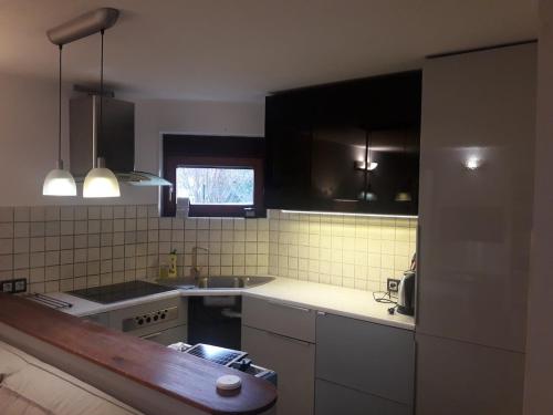 a kitchen with a stove and a sink in it at Quiet and cozy apartment Wroclaw-Widawa in Wrocław